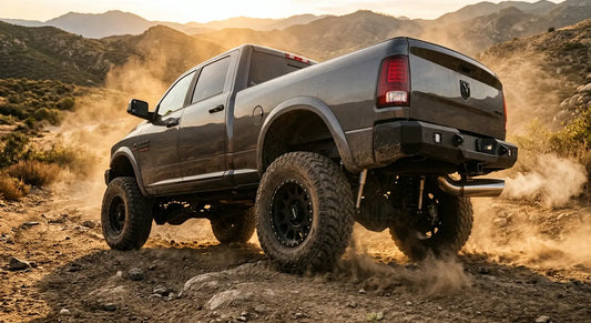 Lifted diesel pickup truck on an off-road trail with aftermarket exhaust system, representing a diesel delete build for off-road use